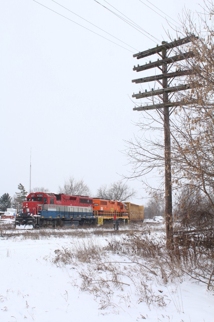 Technology from many decades ago still lingers at Ontario's other Guelph Junction, in Guelph. Not just the aging Geeps but the numerous telephone poles that line the right of way that were once such an essential part of communicating to the outside world. Typically one unit or as of lately the slug set are assigned to train 582 out of Preston, but this day the power typically used by train 580 was assigned to it. The train is in the process of switching from the southern portion of the Fergus sub. to the northern portion as there is no diamond connecting to two sections here. After switching the Guelph north spurs the train will meet up with 580 in the yard to swap crews and cars.