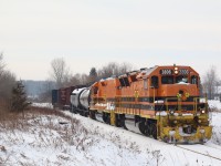 GEXR local 582 slowly meanders through Glenchristie just west of Guelph with a handful of cars in tow. The train is about to cross Regional Road 124. In a few minutes the train will stop long enough to grab coffees at a local gas bar then head onto Guelph for an afternoon of switching local industries before once again returning to Preston for the night.