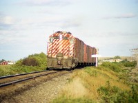 CP GP9 8516 heading westward into the setting sun with a short train in tow. Probably going back to Medicine Hat. It is a shame the glare of the sun blots out the namesign.  This old locomotive was around until very recently, albeit incognito, as CP 8250, which it became in 1997, after some years as 1572 after going thru CP rebuild program in the late 1980s.  Now it has gone to Larry's Truck & Electric. Some never die.