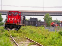 CN 1413's train derailed crossing Dieppe Rd in North St. Catharines and in this photo we see workers arriving on location at the crossing and assessing the situation. We also see a Niagara police officer doing his nonchalant assessment as well, and I waited to see what activity was going to transpire here, while waiting for him to saunter up to me and tell me to clear out. He did. But he was very polite about it. This trackage is no longer, having been lifted quite a few years back.  There was no more industry left in the city north of the Skyway Bridge (pictured)to service. A steel supply company just out of sight in this photo by Bunting Rd/Eastchester is now as far as this line goes.