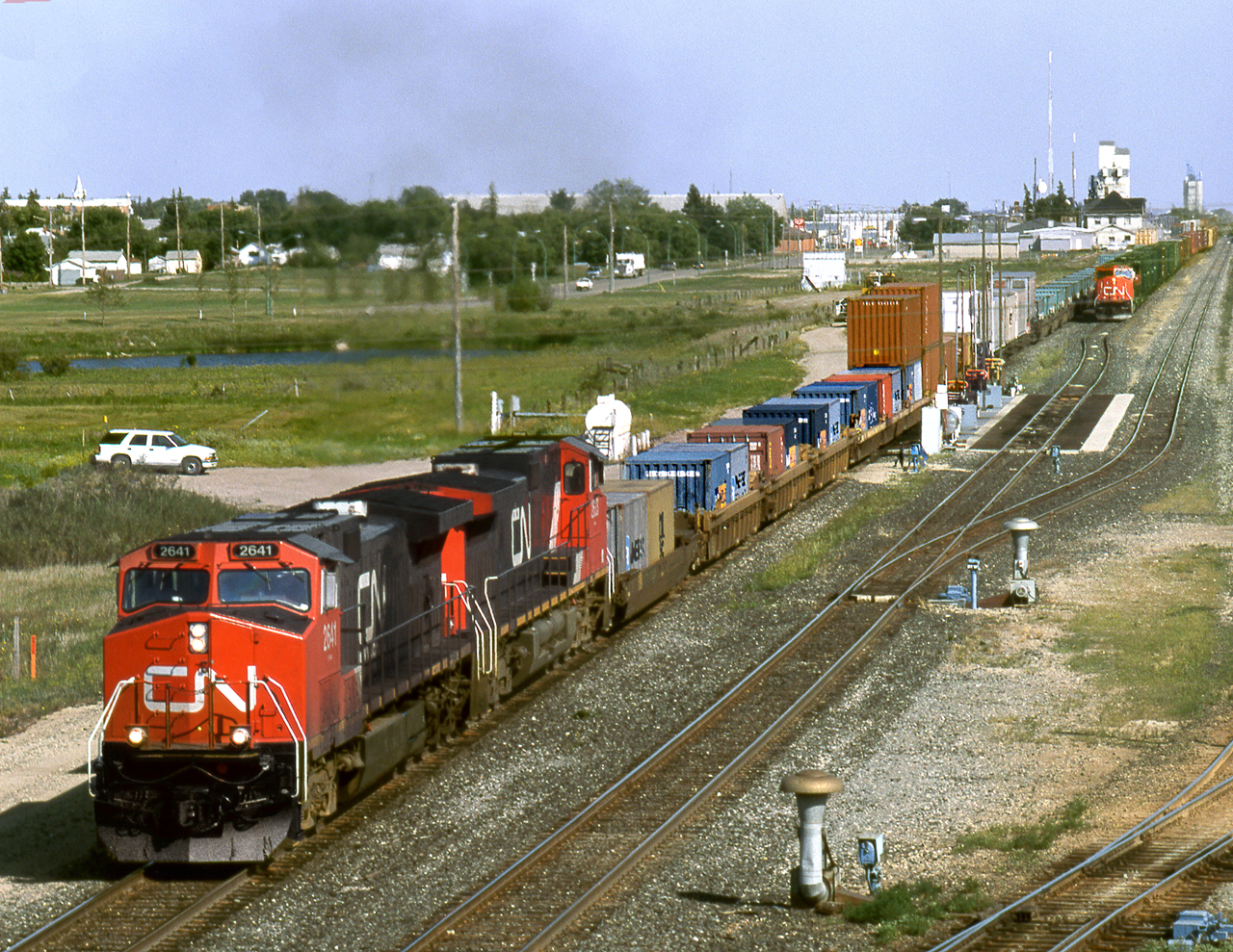 Train 113 departs Melville yard after crew change and fueling while train 357 on adjacent track pulls up to the fuel racks