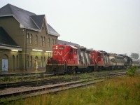 After the SOU 6141 with N&W 1518 shared the spotlight with CN's 6060 steam engine over the past few days, the train (inc some Roanoke Chapter coaches) left Toronto, the site of the National Railway Historical Society convention that year, for its return trip to the States. There were a number of photographers out along the line up as far as Bayview for this special, but late day times and approaching really miserable weather resulted in only one photographer by the time the train made Niagara Falls. Well, two, if you include "the Sidekick" watching the proceedings over by the VIA doors. It was dark, raining, and foggy. About as bad as it could get. For the film guys, I shot this with 100 ISO film, 30th (hand held) at 2.8. I'm lucky I got what I did. The train is stopped for CN leaders 4599 and 4589 to take it Stateside.