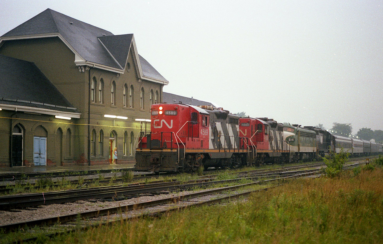 After the SOU 6141 with N&W 1518 shared the spotlight with CN's 6060 steam engine over the past few days, the train (inc some Roanoke Chapter coaches) left Toronto, the site of the National Railway Historical Society convention that year, for its return trip to the States. There were a number of photographers out along the line up as far as Bayview for this special, but late day times and approaching really miserable weather resulted in only one photographer by the time the train made Niagara Falls. Well, two, if you include "the Sidekick" watching the proceedings over by the VIA doors. It was dark, raining, and foggy. About as bad as it could get. For the film guys, I shot this with 100 ISO film, 30th (hand held) at 2.8. I'm lucky I got what I did. The train is stopped for CN leaders 4599 and 4589 to take it Stateside.