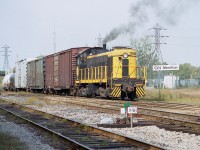 Port Colborne Harbour's  (now Trillium) 308, smokes it up while working CN Merritton yard at mile 9.49 Grimsby Sub. This alco S-1 switcher was built way back in 1946. It served on PCHR only a short time, being shipped off to the New York & Lake Erie RR in 2003. Originally it was Erie-Lackawanna 308, then worked Case International (International Harvester in Hamilton) for a number of years. It is see here in CASE IH colours. Behind this consist the Merritton CN station once stood, destroyed by fire in late 1994.