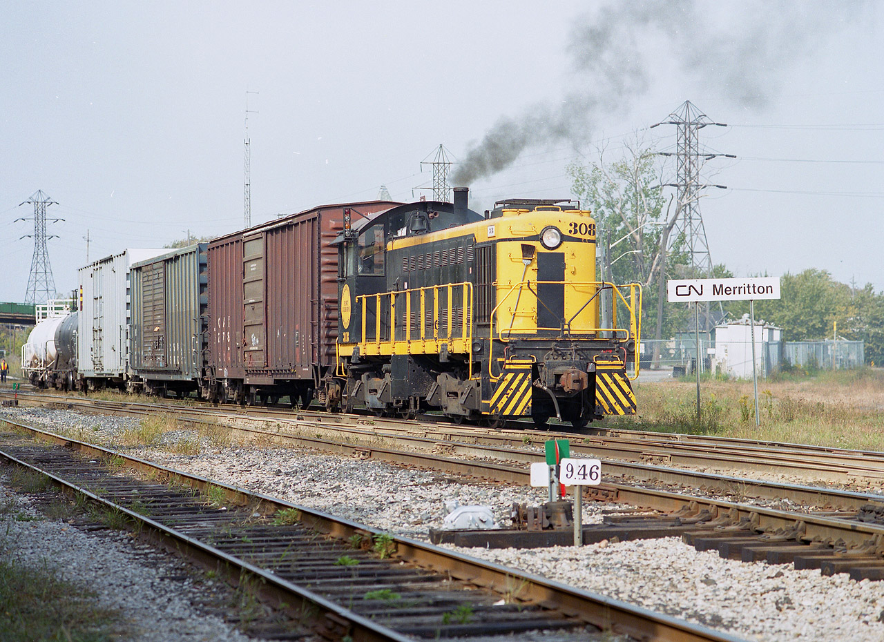Port Colborne Harbour's  (now Trillium) 308, smokes it up while working CN Merritton yard at mile 9.49 Grimsby Sub. This alco S-1 switcher was built way back in 1946. It served on PCHR only a short time, being shipped off to the New York & Lake Erie RR in 2003. Originally it was Erie-Lackawanna 308, then worked Case International (International Harvester in Hamilton) for a number of years. It is see here in CASE IH colours. Behind this consist the Merritton CN station once stood, destroyed by fire in late 1994.