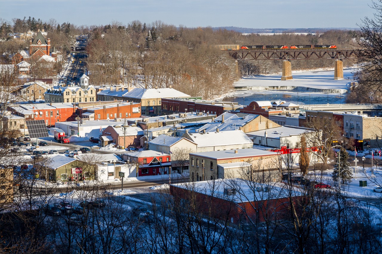 Paris, Ontario slumbers on a peaceful winter's morning as Canadian National train no. 384 rolls over the Grand River trestle, completing the picturesque scene.