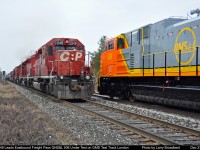 CP Eastbound lead by 5948 accelerates pass SD70ace QNS&L 506 undergoing testing on the GMD Test Track on a unusually warm day December 27 2009 