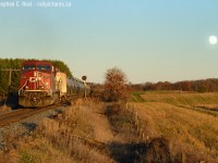 Sunset for Sentinels: While a few people were out photographing OSR's first run on the rest of the Cayuga - I was blissfully unaware instead focused on my final photographs of some Searchlights that I had been planning for months. With limited time in my schedule to 'get out' a final warm and sunny afternoon, a weekend, and 3 hours of free time put me on the 401 to mile 76.2 hoping, praying, that the gods of CP might send me a westbound. Imagine my dismay when I arrive and hear the EOT frequency blaring, then the detector at mile 83.4 going off - bollocks. I missed a westbound, or so I figured. Train 147 usually ran at that time of day. Not to be dismayed, I remembered the  words I supplicated to the CP gods and stayed put. Sure enough, some horns out Blandford way briefly jolted my senses alert, rats, only an eastbound - and darn, this meant I'd have no westbound train! With 10 minutes of light left, I was certain that any possibility of a train at Wolverton meeting this eastbound, and making it to the Sentinels at 76.2 were slim to none. But out in the distance I saw the silhouette of a single unit wonder with oil tanks.. could it be? An oil train? They often have DPU... On cue, I set up my shot, just as the moon started rising on the horizon and watched as many dozens of black DOT111a's blast by me. Among the metallic squeals and bass of the empty tank cars I could hear the growing whine of an accelerating AC4400. As the tail end DPU passed my scene I snapped a few carefully planned frames to try and get as much as I could of this moment. It will be my last -  OSR can wait.<br><br>The epilogue of this is PNR is rapidly replacing the signals all along the Galt sub and so far, all Searchlights are now replaced up to Coakley on the Galt sub, with exception to the '08 installs at Wolverton. Who knows how long the last few west of Coakley will last, it won't be long.