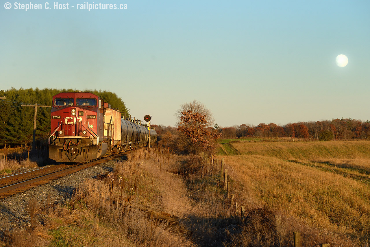 Sunset for Sentinels: While a few people were out photographing OSR's first run on the rest of the Cayuga - I was blissfully unaware instead focused on my final photographs of some Searchlights that I had been planning for months. With limited time in my schedule to 'get out' a final warm and sunny afternoon, a weekend, and 3 hours of free time put me on the 401 to mile 76.2 hoping, praying, that the gods of CP might send me a westbound. Imagine my dismay when I arrive and hear the EOT frequency blaring, then the detector at mile 83.4 going off - bollocks. I missed a westbound, or so I figured. Train 147 usually ran at that time of day. Not to be dismayed, I remembered the  words I supplicated to the CP gods and stayed put. Sure enough, some horns out Blandford way briefly jolted my senses alas, only an eastbound - and darn, this meant I'd have no westbound train!. With 10 minutes of light left, I was certain that any possibility of a train at Wolverton meeting this eastbound, and making it to the Sentinels at 76.2 were slim to none. But out in the distance I saw the silhouette of a single unit wonder with oil tanks.. could it be? A DPU equipped Oil train? On cue, I set up my shot, just as the moon started rising on the horizon and watched as many dozens of black DOT111a's blast by me. Amongst the metallic squeals and bass of the empty tank cars I could hear the growing whine of an accelerating AC4400. At the tail end DPU passed my scene I snapped a few carefully planned frames to try and get as much as I could of this moment. It will be my last. OSR can wait.
The epilogue of this is PNR is rapidly replacing the signals all along the Galt sub and so far, all Searchlights are now replaced up to Coakley on the Galt sub, with exception to the '08 installs at Wolverton. Who knows how long the last few west of Coakley will last, it won't be long.