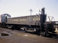 Not your average 'B' unit. This motorized booster is one of only 4 built by MLW. B100 & B101 were built in  1951. Booster unit control locos converted to mother these units were CP 7033,7038 and 7039. Then boosters B102 and B103 (shown) were built in 1957 and three more MLW S-2 switchers were converted for use with these: 7081, 7082 and 7083. In 1966 two more switchers were done...7030 and 7040. All units retired now, (B101 converted to a scale test car) the B103 being the last to die, back in 1984. Unfortunately I did not record the number of the switcher(s) shown. I keep wondering if that puddle in the foreground is oil. Probably not, but many yards were extremely contaminated back then.