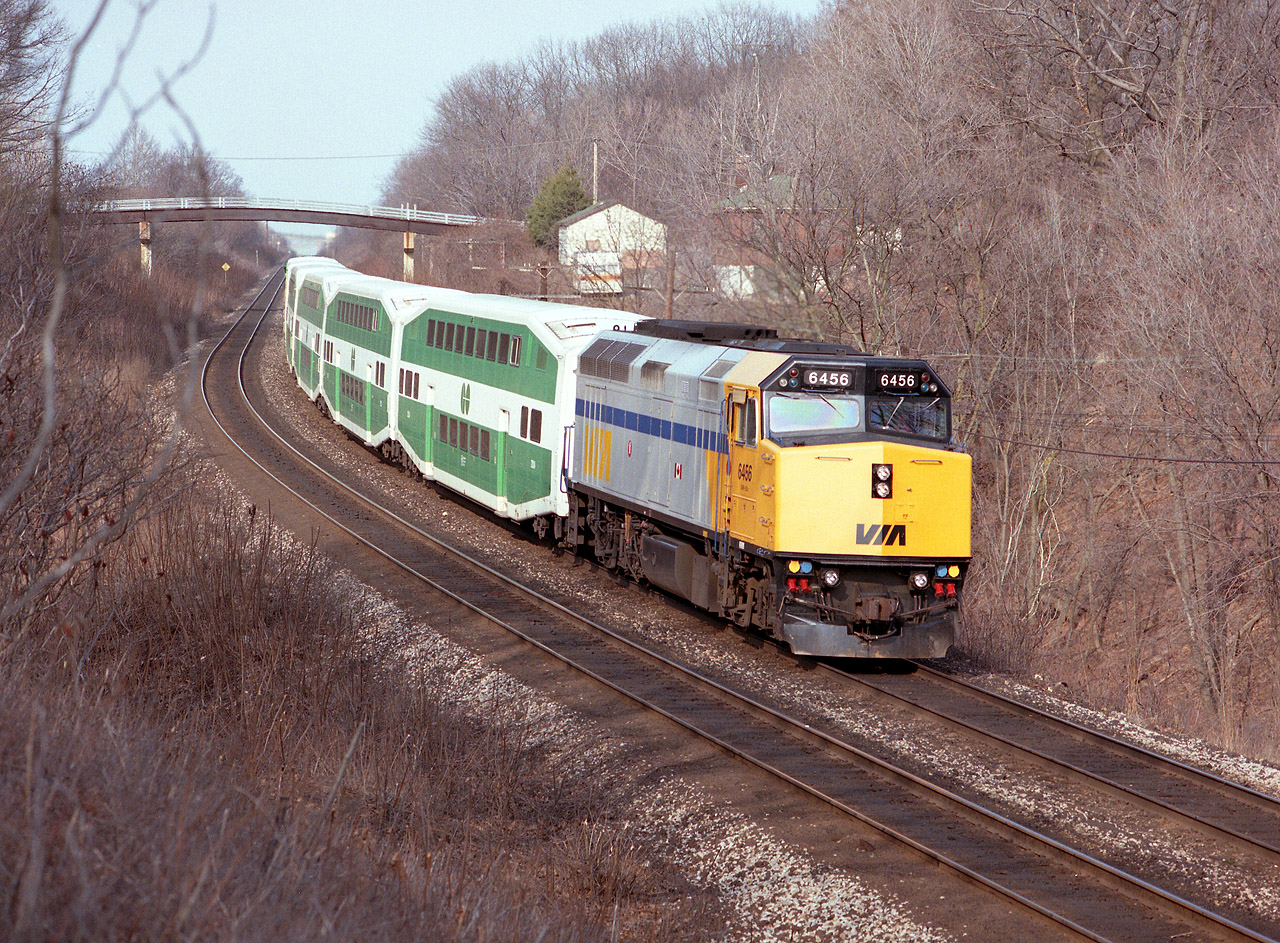 While VIA coaches were having problems and undergoing wheel/axle inspections and as a precaution were out of service, VIA made do with GO equipment for a time in early spring 1992. It gave photographers the opportunity to see some very unusual combinations, witness this VIA #75 heading west, just coming up to Bayview Jct. That is the old Snake Rd bridge in the background.