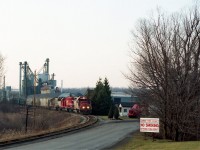 Grain Train!!  Always nice to see, but alas, this was 25 years ago; and now they all seem to run Stateside or around the Lakehead. It has been a long while since I have seen one thru Niagara. Here is an all-SOO lashup; SOO 6411, 779 and 6013 passing the old Waterdown station, now offices of the SunOPTA Minerals Inc company which is on Parkside Drive in North Waterdown. This train probably ran thru to the Port of Albany, NY. Dispositions: SOO 6013 went to Indiana RR in 2006. SOO 6411 (became CP) went to DME in 2000. SOO 779 (became CP) retired.