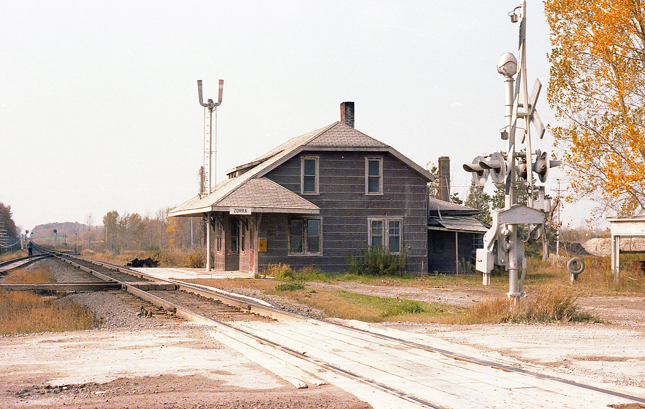 If one was to drive up 35th Line north off of old Hwy 2, just west of the Lafarge plant; cross the tracks and pull into the short drive on the left, remnants of an old station can be seen. Not much, just some rusted scrap, a pole, and the row of bushes. This rather important structure stood where the CP line came down from St. Mary's, joined the Galt sub running eastward for a 100 feet or so and then branching off in front of the Zorra Station and continued down into Ingersoll and onward to Port Burwell. The Zorra to Ingersoll track has been gone for many years; until 15 years or so ago just the spur into what was St. Mary's Cement remained. As well, all but a half mile off the Galt toward St. Mary's has been removed. The last train over the St. Marys length ran in 1995. I am not sure what year the Zorra station was removed, perhaps around 1981, but it was leveled suddenly and without fanfare. Rumour has it that a hole was dug and the station was demolished and buried on the site. A real shame. I found it a very attractive building, despite most of the time being shrouded in dust from the nearby cement industries.