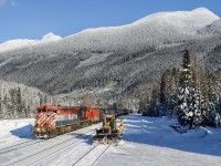 BCOL C40-8M 4626 leads train U743 down the north track at Clemina passing a ballast regulator turned snowplow parked in the backtrack.