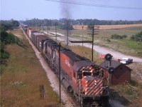 This was once the site of a very nice old Puslinch train station. I believe it disappeared in the mid 1960s, and all there is now is a MoW shed and signal as seen in this view from the side of Hwy 6, taken 42 years ago as of this posting. Power on this eastbound, moving at speed, is CP 4733 and 8599, still in old paint scheme. When I look over this scene, it brings back the feelings of the much less stressful years...........