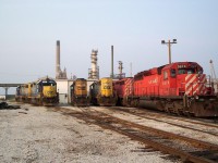 All finished for the day at the CSX engine shop in Sarnia. This was back when CSX was still running their traffic from Sarnia to CP in Chatham for interchange and at that time was utilizing CP locomotives on the job (train D725) If i recall correctly this only lasted from 2003-2006. All traffic since has been interchanged at the CN yard at Sarnia. 

The pair of CSX "canadian" GP38-2's to the left were most likely run on the D724 turn from Sarnia to Chatham and onto Blenheim Ontario as they were still serving the large WG Thompsons grain facility at that time. 

The single GP38-'s in the middle of the shot were used for yard jobs and various customer switching in the Sarnia area. 

Much has changed since this photo in terms of what trains are running on CSX now, no more CP power will be found and CSX has greatly diminished its service to the south of Sarnia. 