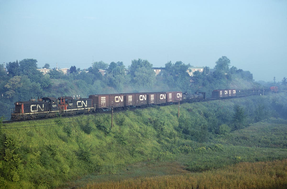 Morning fog is just burning off in the Don Valley as 2 SW1200RS's lead a local freight under Lawrence Ave. We were there waiting for the ONR train coming in and got a pleasant surprise when this freight rolled through first.
