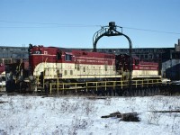 TH&B GP-7 #73 and NW-2 #53 share a ride on the Chatham Street turntable on February 28, 1982.  Both units wear the road's attractive cream and maroon paint that the first diesels delivered in 1948 wore.  #53 was part of that order. The TH&B is one of the few roads to keep a consistent diesel paint scheme for such a  long run (1948 - 1987)