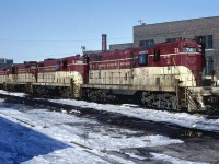 The power for a unit train down to Port Maitland sits on the ready track at the Chatham Street roundhouse on the morning of February 28, 1982. We'd be a little disappointed that they spoiled the solid lash-up with a trailing CP MLW but a bigger disappointment was that the clera skies didn't hold up long enough.
