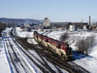 The power for a unit train bound for the fertilizer plant in Port Maitland leaving the ready track at the Chatham Street roundhouse on February 28, 1982.  