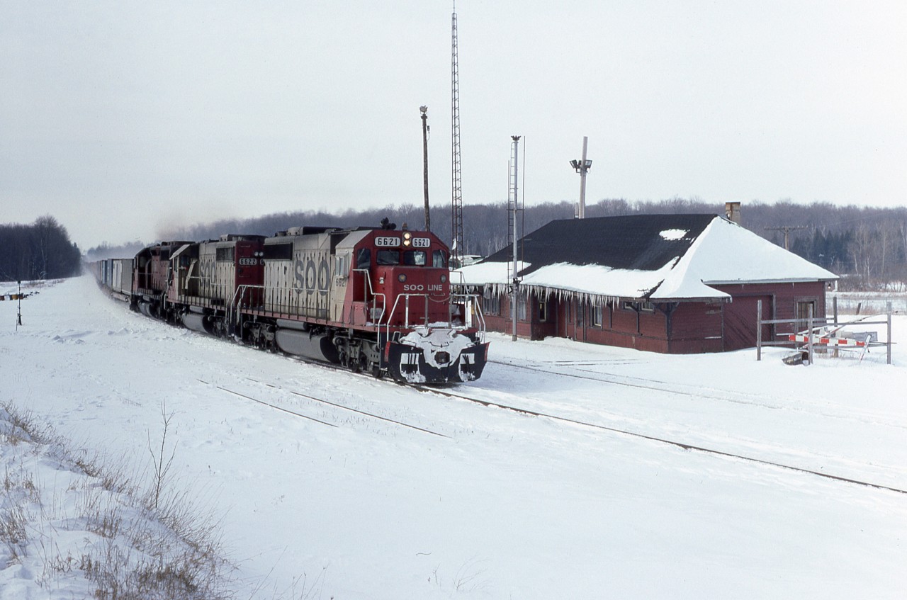 CP No. 500 lead by SOO6621-SOO6622 coasts by the derelict and soon to be demolished Guelph Jct depot on a chilly Feb 15th 1988.