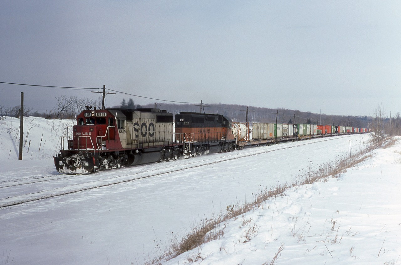SOO 6618 with white flags leads Milwaukee Road 202 on train No 501 through Guelph Jct, Ont.