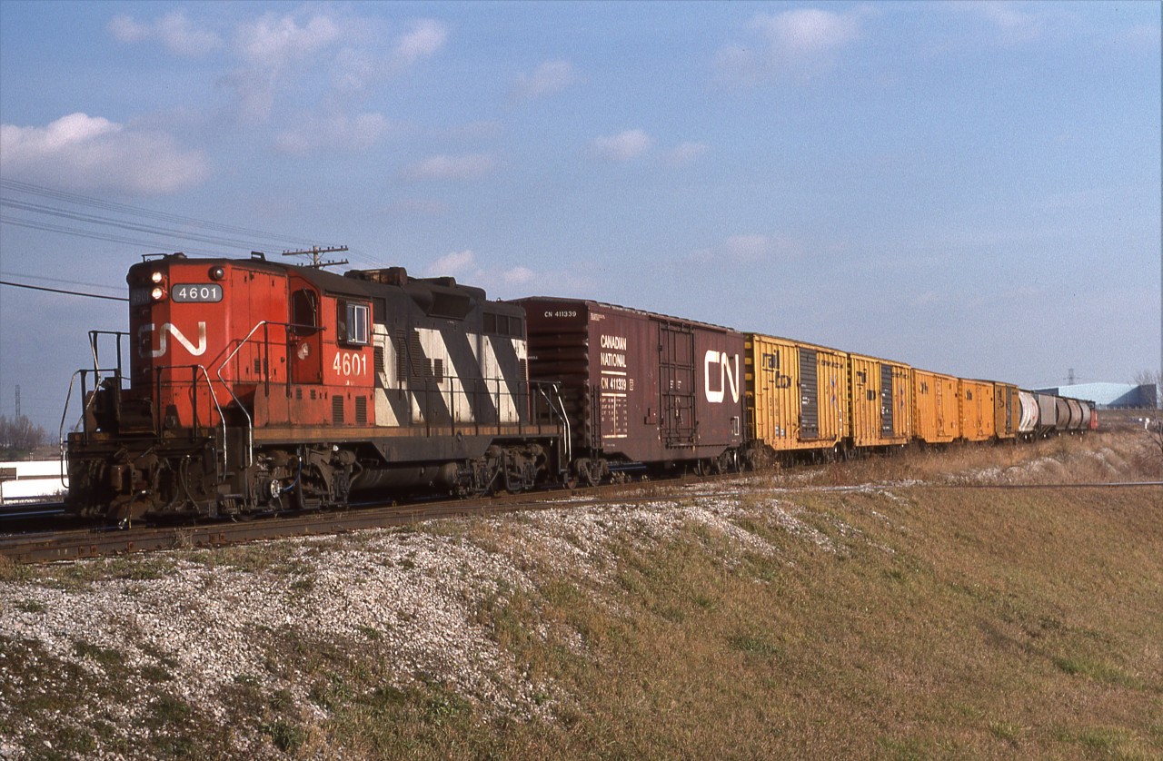 CN GP9 4601 handles a local freight approaching South Blair St crossing in Whitby, Ont