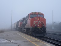 CN 2940 with CN 2872 leading train 397 out of the fog on a slow roll through Sarnia.   