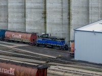 NREX 700, a NRE 1GS7B, waits outside the dumper at Richardson Pioneer grain terminal, which is within CN's Lynn Creek Yard Terminal. The engineer seems to be having a nice nap.