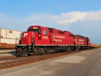 Yard set with GP38-2 3065 and nearing the end of it's career GP9 8207 pulling a string of new spine cars.