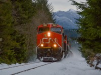 571 was an interesting train on New Years Day 2017. After the crew arrived to work in Squamish, they got on their power (CN 2861 and 8816) and coupled to 546, which incidentally had just arrived a few hours earlier BCR 4610 in the lead position. The railfans of Squamish held their breath as the crew discussed putting their power in the lead, or that of 546, which would have meant a BCR unit leading a train in her home territory twelve and a half years after the provincial carrier was absorbed into CN. 
After much debate, the crew settled on 2861 to do the honours. Too bad. After that, 571 started their work in the yard, and we left the yard for Brackendale, as we knew the train would soon depart Squamish for Lillooet. <br> Seen in this shot is 571 kicking up a snowsquall as it picks up speed on the straightaway in Brackendale. Today's train was light, a mere 1600 feet, consisting of 21 empty gondolas bound for the copper loadout at Gibraltar near Williams Lake.