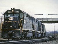 <b>CASO Sub</b> Westbound NYC 3082 rounds the curve under the farmer's wooden bridge at Clanbrassil, ON. in May 1968.  The tracks are long gone but the roadbed is still visible on Google Maps.  