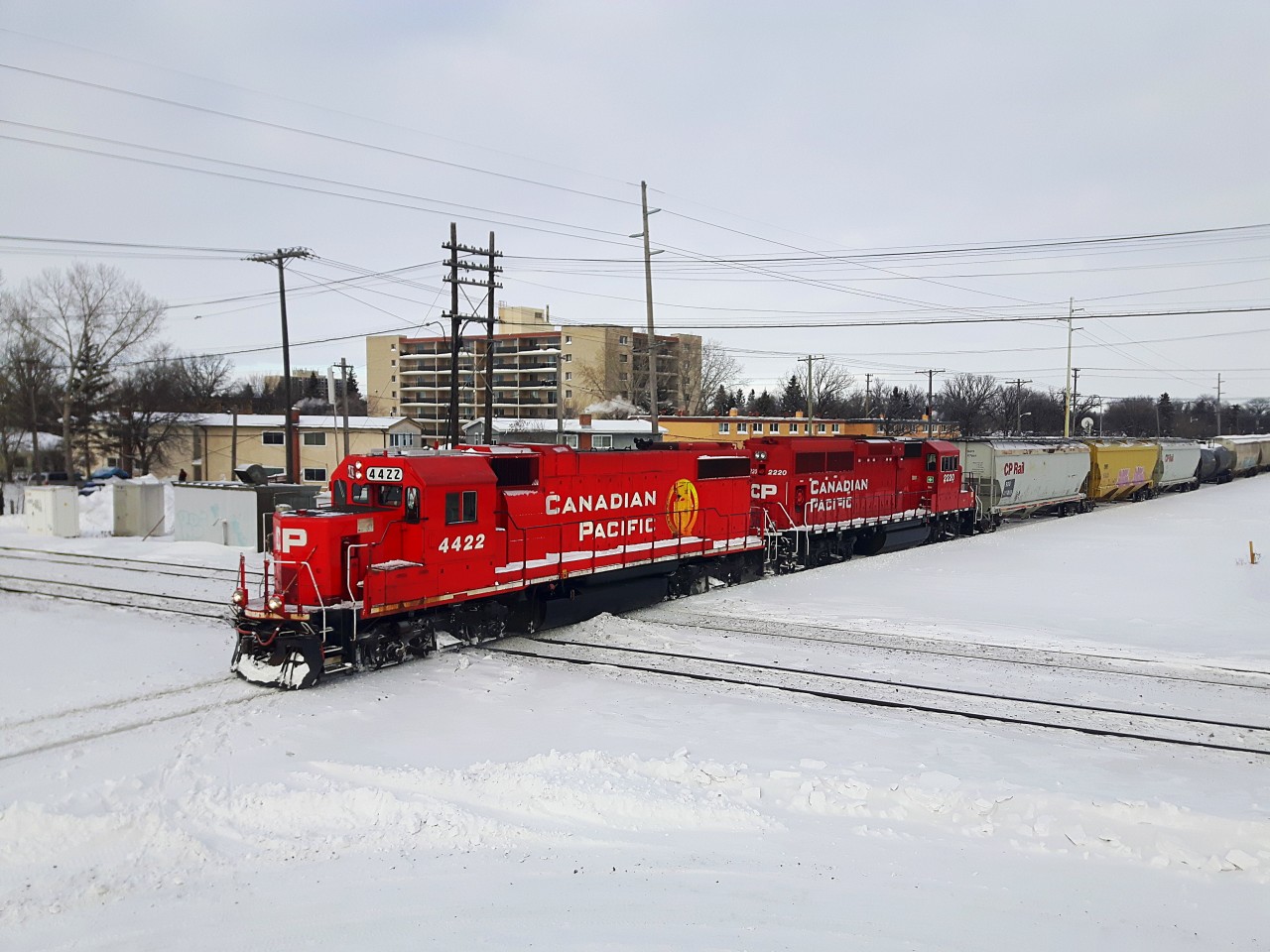My First CP Train of 2017CP 4422 and 2220 lead the southbound Altona freight on the CP La Riviere Subdivision with some covered hoppers and a bunch of black tanks, as they start to cross the CN Rivers Subdivision.