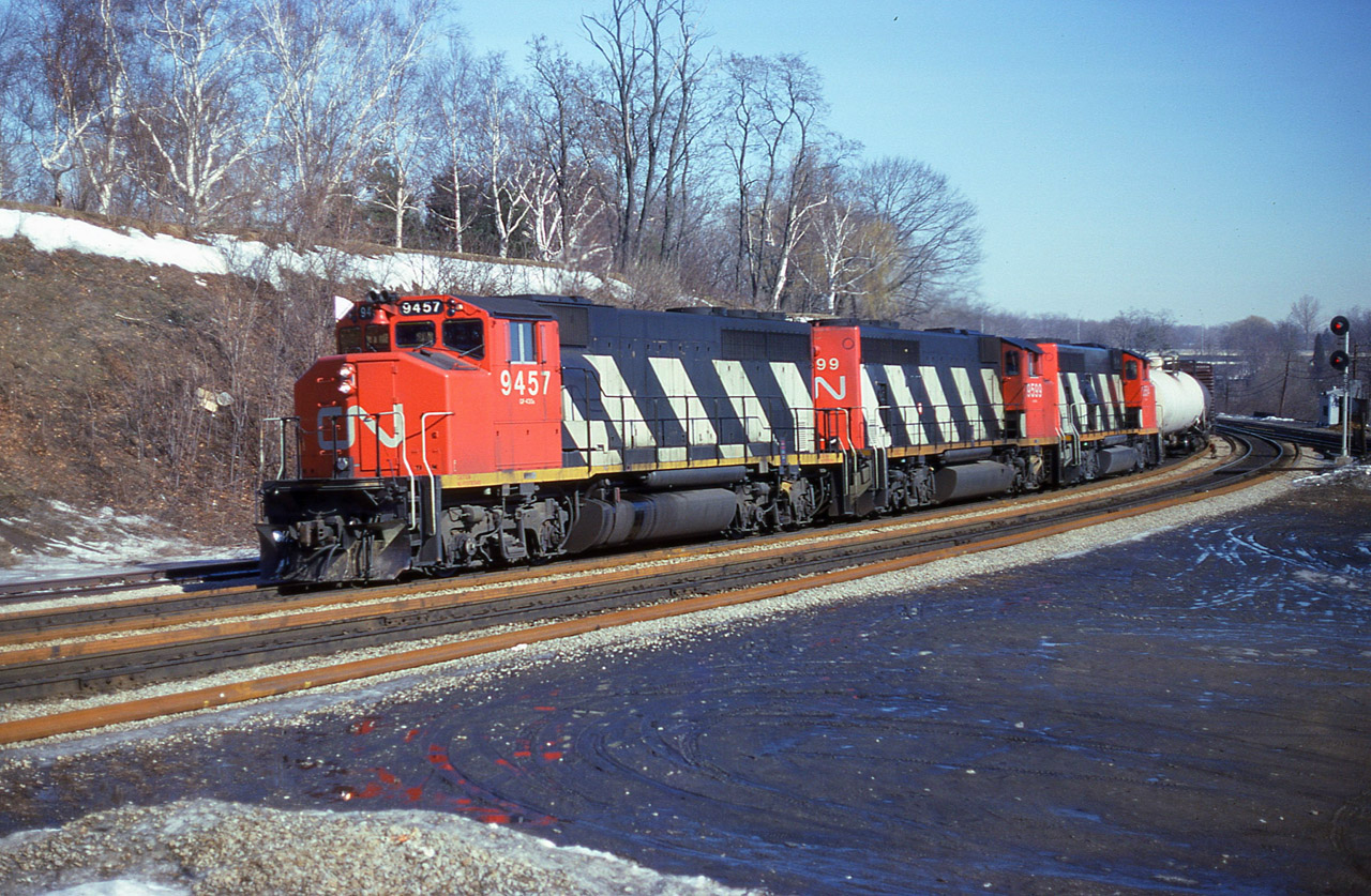 Just a nice clean shot of a trio of GP40-2L(W) heading west thru Bayview Jct on a nice sunny Wednesday morning many moons ago. CN 9457, 9599 and 9554 made for a commonplace photo back then, but they have a nostalgic appeal these days. I enjoyed weekdays at the Jct because it was far less busy with various railfan automobiles parked every which way.