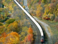 The now-defunct CN #144 trailer train tries best to impersonate the ribbon-rail it is polishing as it snakes downward toward Bayview Jct, about 4.7 miles out. This view from up on Dundas Peak, as much it is beautiful, requires either a good eye or an assistant with binoculars in order to pull in the engine numbers. On this day, I had neither.