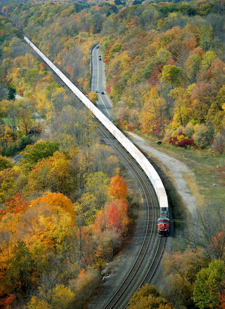 The now-defunct CN #144 trailer train tries best to impersonate the ribbon-rail it is polishing as it snakes downward toward Bayview Jct, about 4.7 miles out. This view from up on Dundas Peak, as much it is beautiful, requires either a good eye or an assistant with binoculars in order to pull in the engine numbers. On this day, I had neither.