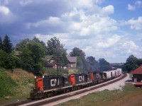 Back in the summer of 1974 on a beautiful day we see CN 4569, 4592 and 5050 westbound past the location of the old Paris station. This image was taken from the side of John St where it passes over the CN main. The end of train caboose is barely visible on the other side of the huge Grand River bridge, a Paris landmark.