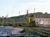   A low rumble always proceeds the appearance of another C&O freight as it struggles to haul it's Train around the sharp curve off of the ex L&PS Main onto the CASO Canada Division at Ross Street St Thomas.       April 1975
