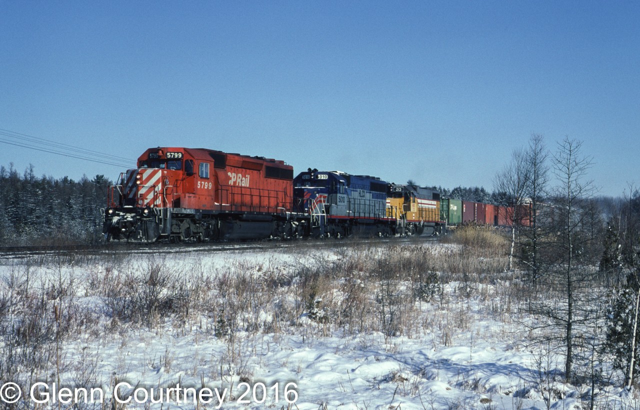 I'm going back just over 22 years to find some snow! CPR SD40-2 5799 leads a pair of Helm Leasing units through the frozen swamp west of Puslinch. The second unit is a former VMV demonstrator, the third is obviously former Union Pacific.