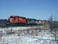 I'm going back just over 22 years to find some snow! CPR SD40-2 5799 leads a pair of Helm Leasing units through the frozen swamp west of Puslinch. The second unit is a former VMV demonstrator, the third is obviously former Union Pacific. 