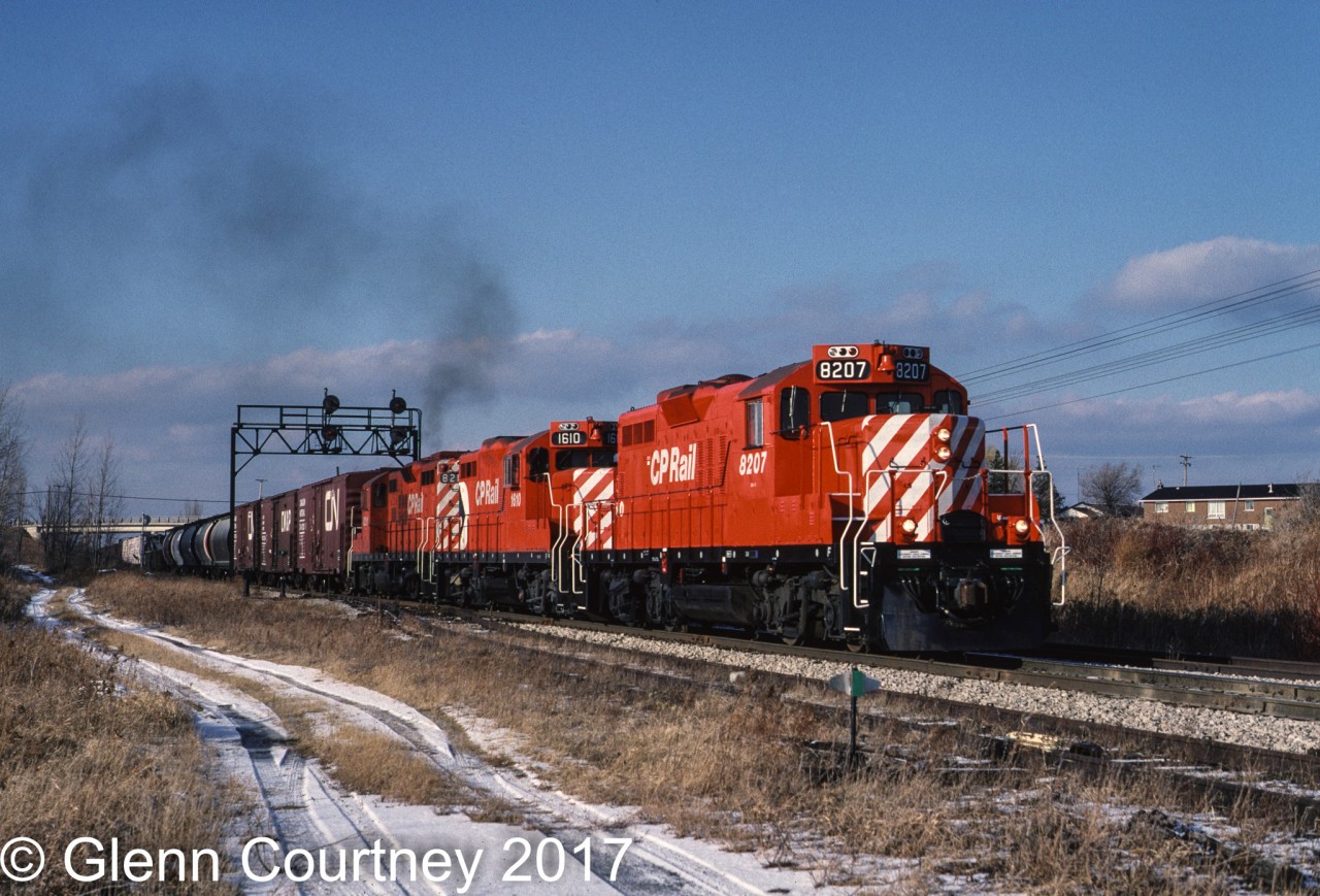 By time I moved to Ontario in 1986 seeing TH&B locos on the road was pretty much a thing of the past as the CP Rail takeover was in full swing. So I had to content myself with shiny new rebuilt GP9u's. Here's a trio cresting the grade (with the help of a TH&B switcher pushing) at Vinemount heading east.