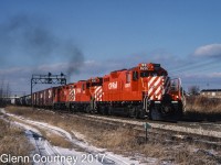 By time I moved to Ontario in 1986 seeing TH&B locos on the road was pretty much a thing of the past as the CP Rail takeover was in full swing. So I had to content myself with shiny new rebuilt GP9u's. Here's a trio cresting the grade (with the help of a TH&B switcher pushing) at Vinemount heading east. 