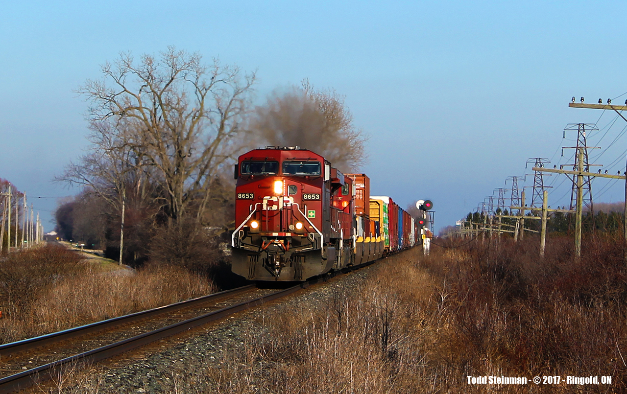 FINALLY!!!...and Happy New Year! Since having relocated to the Chatham area, I have found my luck being somewhat down in trying to photograph the busy Windsor Subdivision of the Canadian Pacific Railway. Out with my family, it was my wife who actually spotted this westbound...and behold, my luck had changed! CP 8653 and a second unidentified unit approach Third Line crossing at what the CP considers of being the small hamlet of Ringold.
