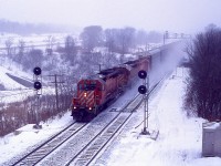 Back when CP used to exercise running rights over the CN along the Oakville sub we see what I believe is #522. Toronto to Buffalo. This image was taken off the Lemonville Rd bridge in Aldershot, once a favourite location for trainwatching on account back then there was little road traffic and plenty of rail traffic. These days, it is the other way around. CP 5538, 5412 and 8241 is the power for this train, running at speed thru light blowing snow. All units now off the CP roster, the 5412 is X-QNSL 216.