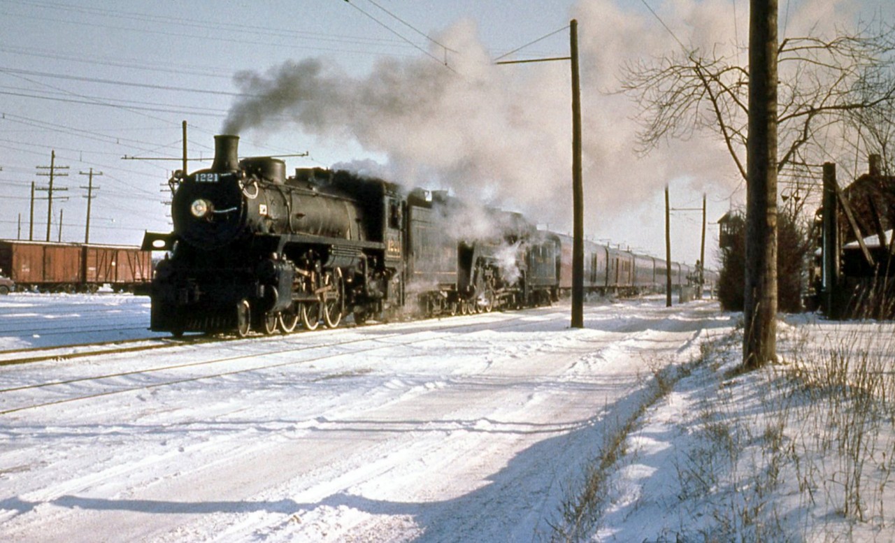 The last steam-powered run of Canadian Pacific train #21 the "Chicago Express" is seen crossing Dundas Street west of the station in Galt, Ontario in January 1954. CPR G5-class light Pacific 1221 and G3-class semi-streamlined Pacific 2409 head up the usual passenger consist. Due to a pending fireman's strike in January 1954, steam replaced normal diesels.

(Original photographer George Schaller, duplicate slide from the collection of Bill Thomson and posted on behalf of and with Mr. Schaller's full participation).