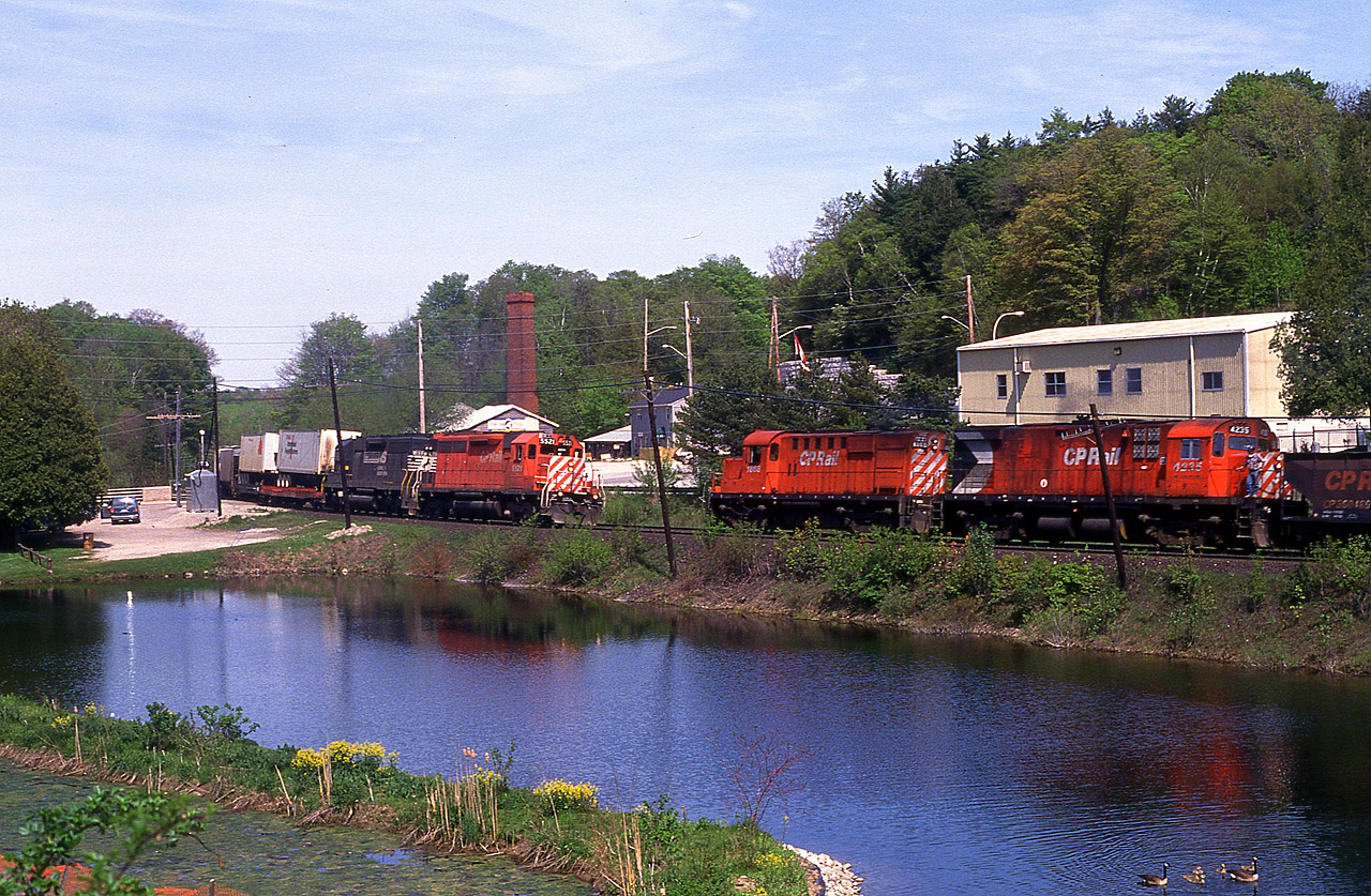 A bit of 'action' on the Galt sub!! Looking across the pond at Campbellville, we see CP 5521 and an unidentified NS leaser westbound as it crosses Guelph Line and meets CP 1858 and 4235, work train. Meets here were very hard for me to come by.