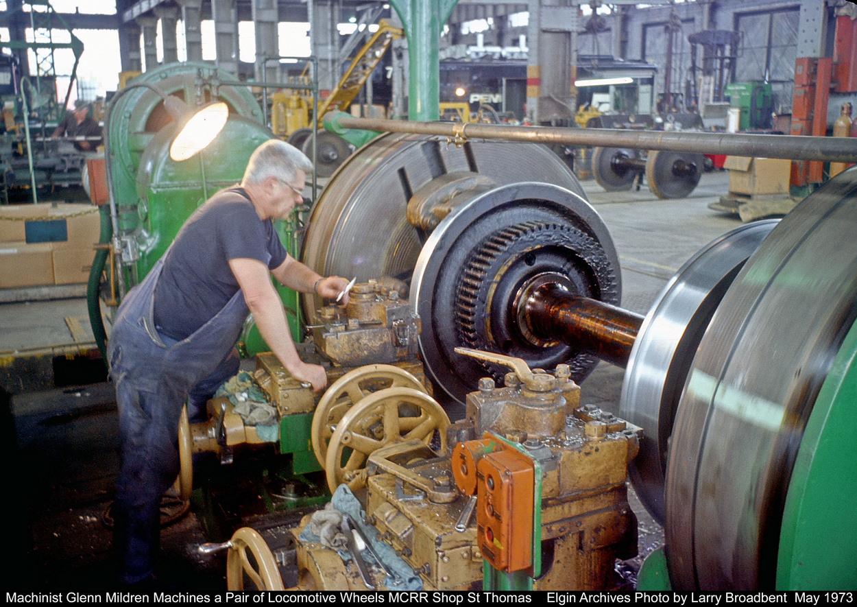 Machinist Glenn Mildren turns a pair of Locomotive Wheels in the MCRR Shop in St Thomas. When making the rough cuts of 3/8 of an inch with a Carbide Cutter this Machine would send vibrations that could be felt through out the shop.The cuttings would come off Red hot and looked like heavy duty Truck Coil Springs.