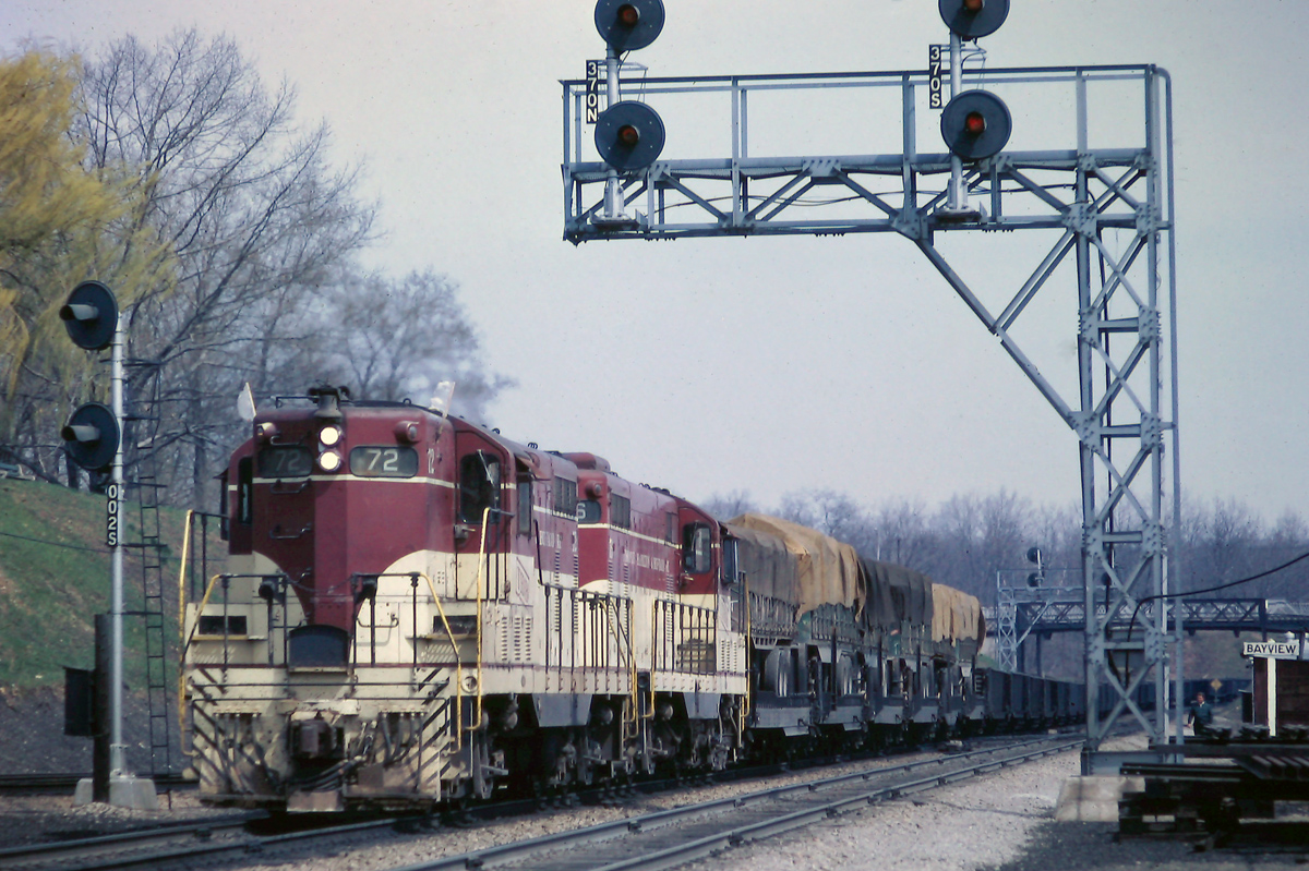 TH&B 72 and 76 are in charge of the westbound Starlight at Bayview Jct, May 1968.  Notice the 6 tarped TOFC loads at the head end of the train.