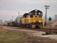 With downtown Detroit looming in the background we see Essex Terminal SW8 105 and SW14 104 haul 39 cars through the ETR-CP interchange yard, where they will drop a handful of cars from ADM for CP before heading over to CN for interchange. The train consists of two alcohol cars from Hiram Walkers-which were picked up that morning- five gondolas to be interchanged with CN bound for Zalev Bros Scrap and 32 cars from ADM after a morning of switching on Windsor's west side.