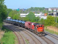 CN 711 is departing Turcot West after a crew change with CN 2117 and CP 9556 in May 2014. CN 711 was an empty oil train running from Joffre Yard near Quebec City to interchange with BNSF near Chicago. It has not run since the spring of 2015.